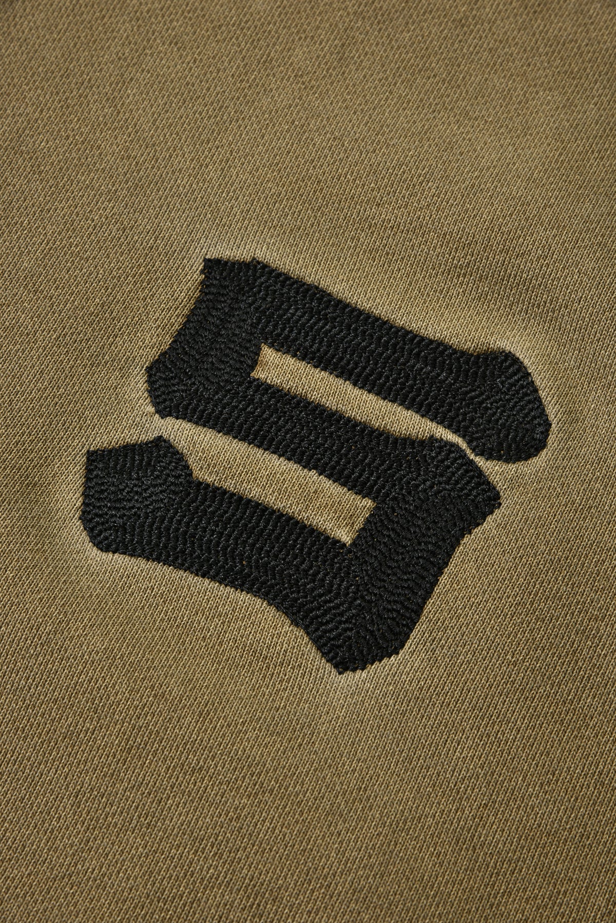 Black logo on a beige background